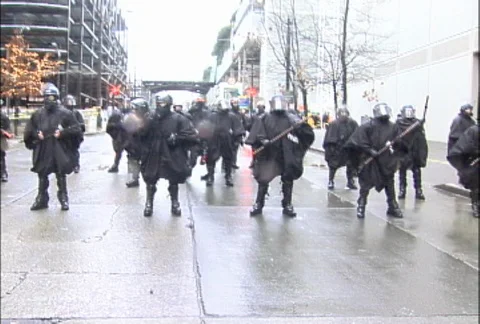 Police with Batons Blocking Street at WTO Protests Stock Footage 106959288