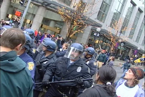 Police with Batons Pushing Through Crowd at WTO Protests Stock Footage 106961301