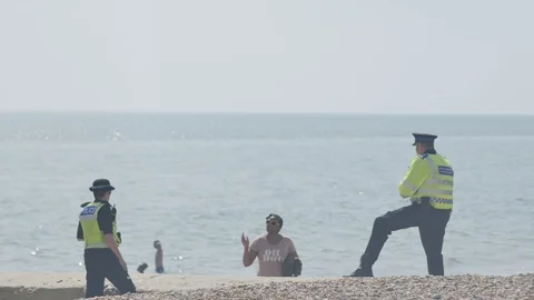 Police on the beach 6 Stock Footage 130062206
