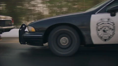Police Car chasing a person in another car and getting really close Stock Footage 283108879