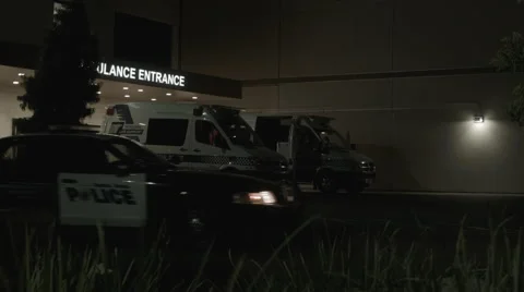 Police Car Drive-By at Hospital Stock Footage