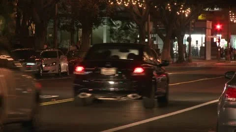 A police car drives on a downtown Los Angeles street at night. Stock Footage