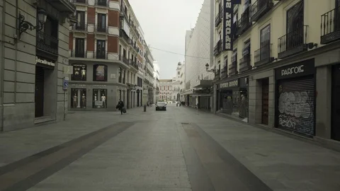 Police car drives by Madrid empty street Stock Footage 127607366