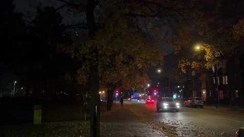 Police Car Drives through Intersection Stock Footage 220383587