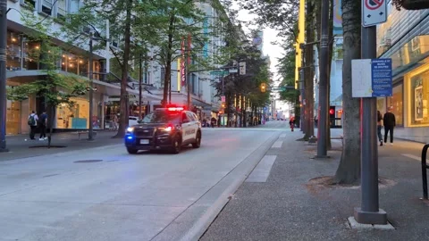 Police car driving fast through the city street, front street view. Stockbeeldmateriaal 345301366