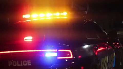 Police Car with Flashing Lights Parked at a DUI Sobriety Checkpoint at Night Stock Footage