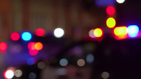 Police car flashing lights while parked on street at night Stock Footage 240363755