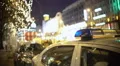 Police car at mass protest site, officer patrolling crowded city street at night 4k or 4k+ Resolution