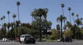Police Car Passing by , Traffic in Beverly Hills, Palm Trees, Los Angeles, USA HD Footage
