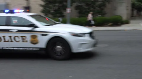Police car races past Stock Footage
