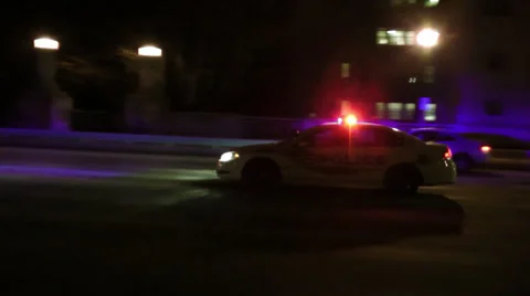 Police car speeding by, night, gritty, urban, siren, stock footage Stock Footage