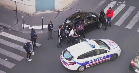 Police control the behaviour of a group of multi-ethnic street youth Stock Footage 130794083