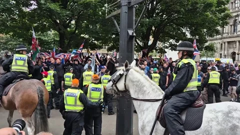 Police controlling Pro-UK demonstrators at a Pro-Palestine, Glasgow, UK Stock Footage 283894341