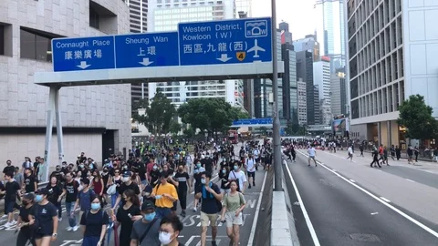 Police decide to end the assembly early and deploy. Peaceful protesters panic. Stock Footage 115707096