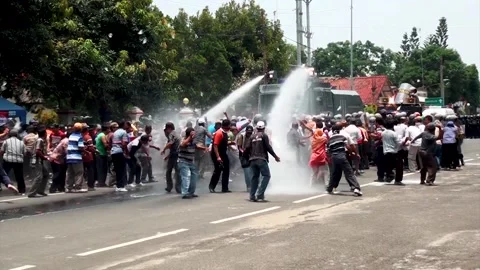 Police deployed water cannons and tear gas at the protesters. Indonesia Stockbeeldmateriaal 148653780