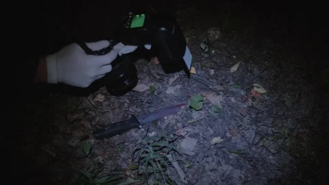 Police detective taking evidence picture... | Stock Video | Pond5