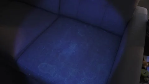 Police detective using a black light to search for clues Stock Footage 304293637