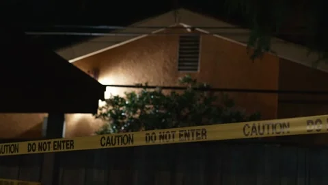 Police do not enter tape at night near residential house with lights Stock Footage 334012297
