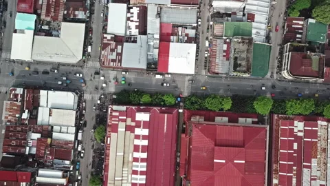 The police drone flies over poor neighborhoods. Uncontrolled traffic below Stock Footage 99675064