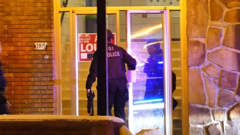 Police entering into building Stock Footage 103288803