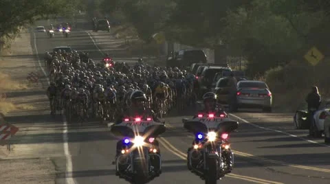 Police Escorting Cyclists In A Road Race Video stock 19141038