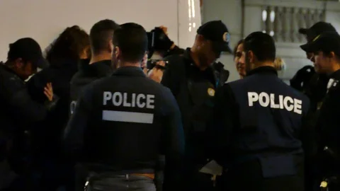 Police filming a suspect Stock Footage 120062993