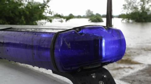 Police flashing light blinking in focus. Flood muddy river came to the road. Vídeos de archivo 38854745