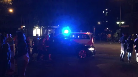 Police with flashing lights at intersection during evening traffic 스톡 동영상 56969564