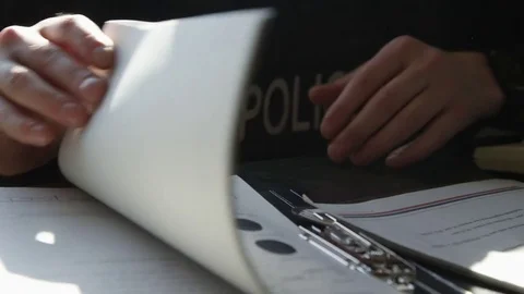 Police going through reports Stock-Footage 72971974