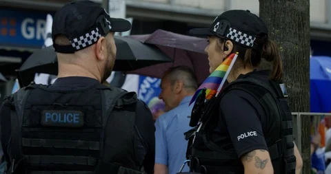 Police Guarding Pride Parade With Rainbow Flags Umbrellas And Signs Stock Footage 113523060