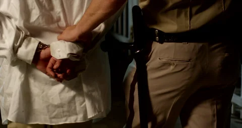 Police has guy in handcuffs 2 outside night 4k Видео 293044856