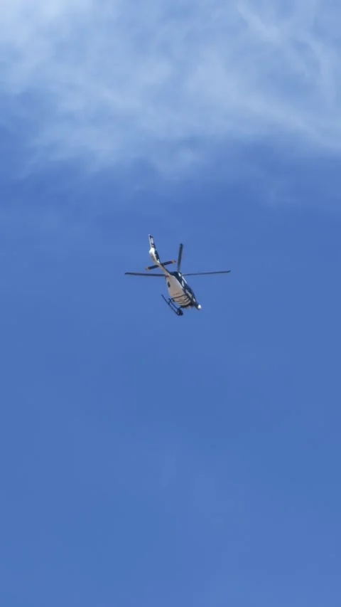 A police helicopter hovering motionless during a security surveillance operation 스톡 동영상 333702083