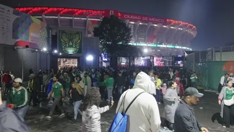 Police in high-visibility jackets outside Estadio Azteca at night Stock Footage 345278487