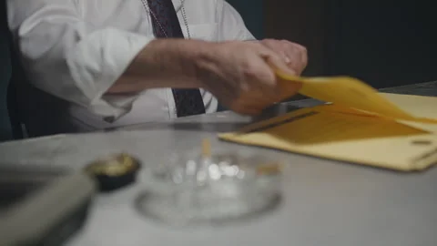 Police interrogation detective close up of documents and hands Stock Footage 267893134