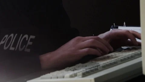 Police on keyboard of computer - typing reports on computer - law enforcement Stock Footage 72761586