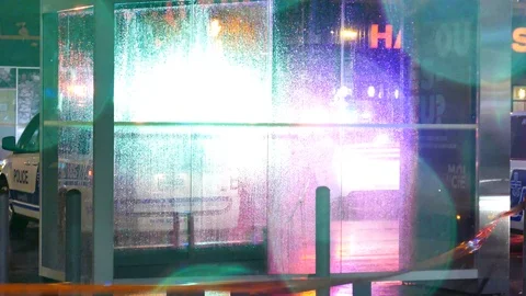 Police with lights through bus station at rainy night Stock Footage 105346233