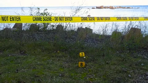 Police line crime scene tape, crime markers next to bullets ammunition on a Video stock 320074853
