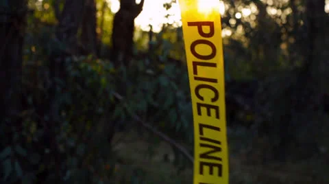 Police Line Do Not Cross Yellow Tape in Wind Stock Footage 22606792