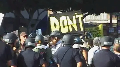 Police Line in at protest with large "Don't" sign Video stock 94228467