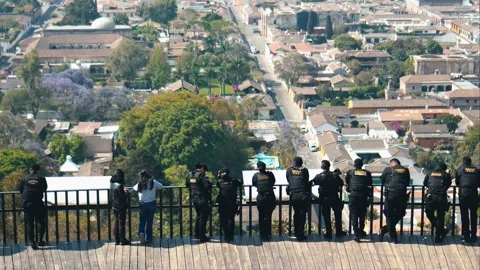 Police lined up looking at view of Antigua Guatemala Stock Footage 273810122
