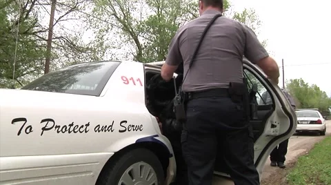 Police loading suspect Stock-Footage 42874355