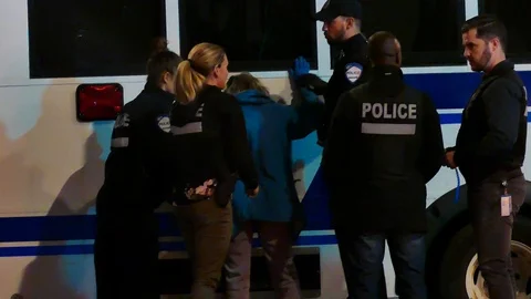 Police making the arrest of an old desoriented woman Stock Footage 120062846