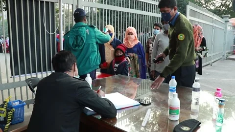 Police man are checking temperature for covid 19 and giving hand sanitizer . Stock Footage 146773104
