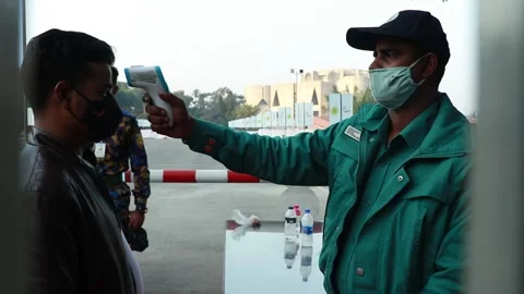 Police man are checking temperature for  covid 19 and giving hand sanitizer . Stock Footage 146773236