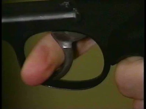 A police man pulls the trigger of a device similar to a gun in 1994. 動画素材 75300473