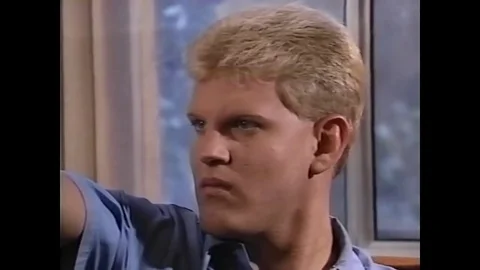 A police man pulls the trigger of a device similar to a gun in 1994. 動画素材 82389639