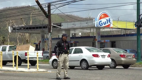 Police man standing in the middle of the road watching traffic in Puerto Rico Stock Footage 82031601