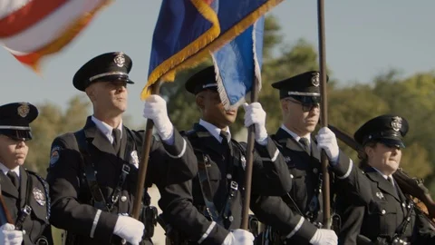 Police marching in a parade with flags Video stock 100004801