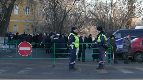 Police monitors the queue to church Video stock 46039504