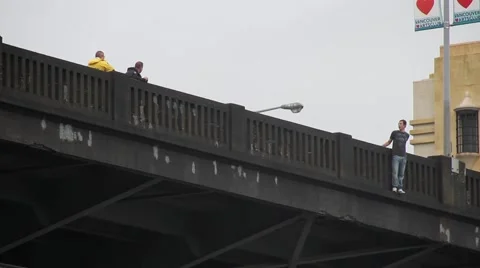 Police negociators talking with suicidal man on bridge Stock Footage